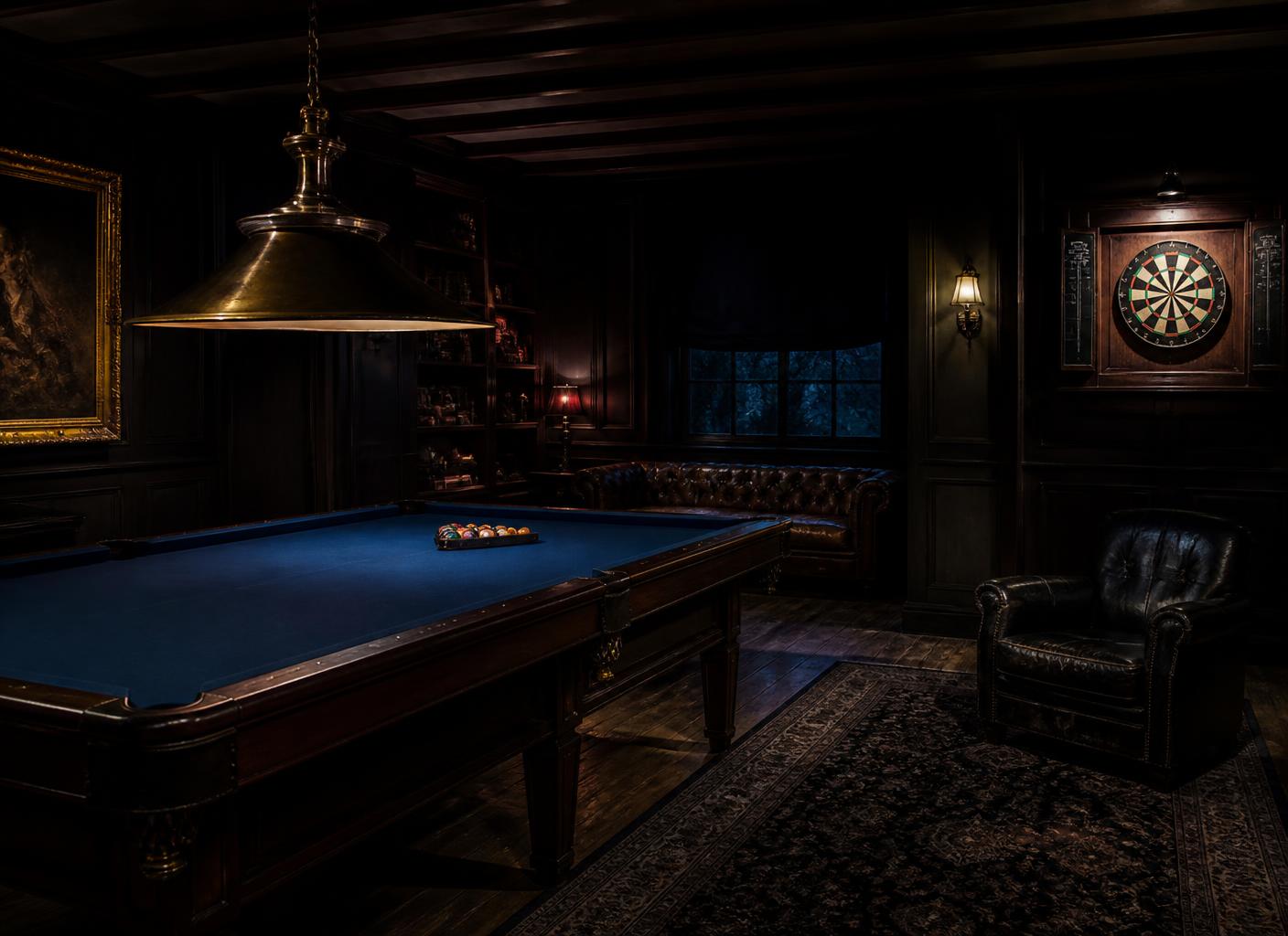 A pool table under a low brass lamp in a dark games room